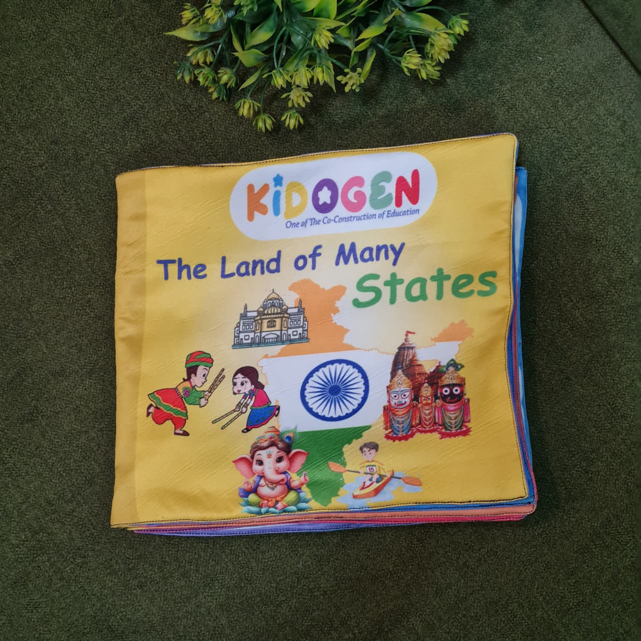 "The Land of Many States" fabric book by Kidogen, showcasing an Indian map, traditional dancers, temples, Ganesha, and a boat, with the brand logo.